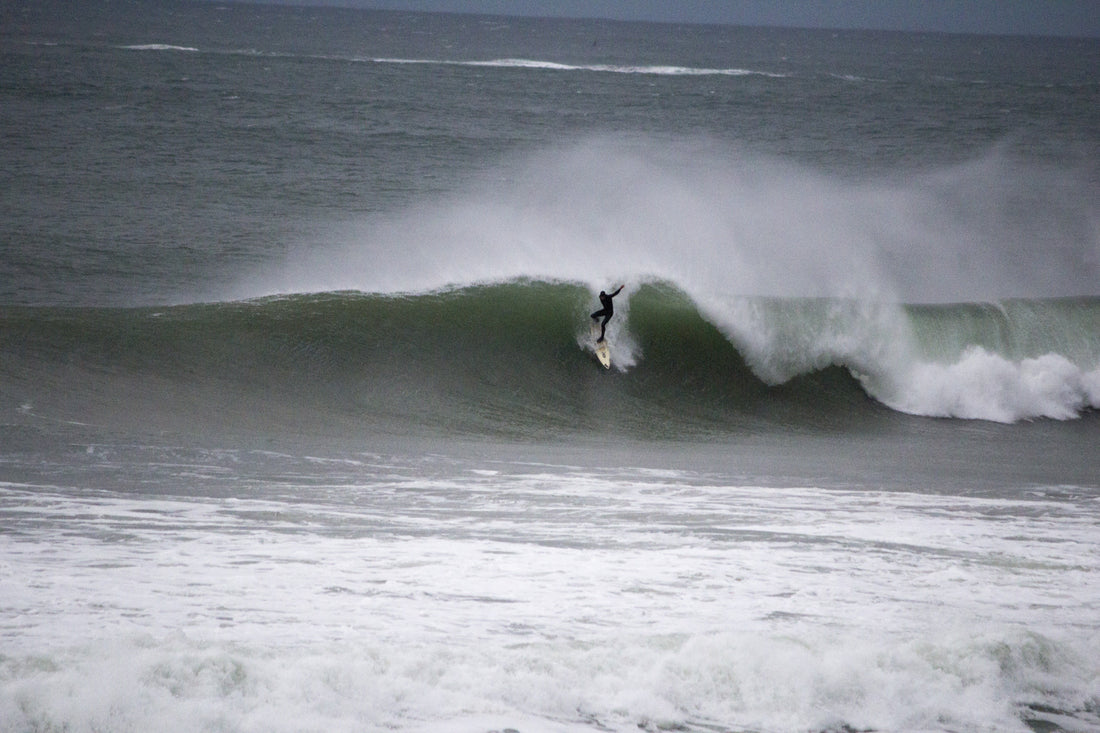A surfer riding a wave at Portrush, Northern Ireland