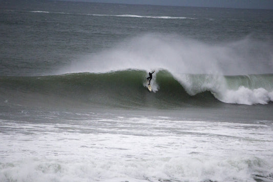 A surfer riding a wave at Portrush, Northern Ireland