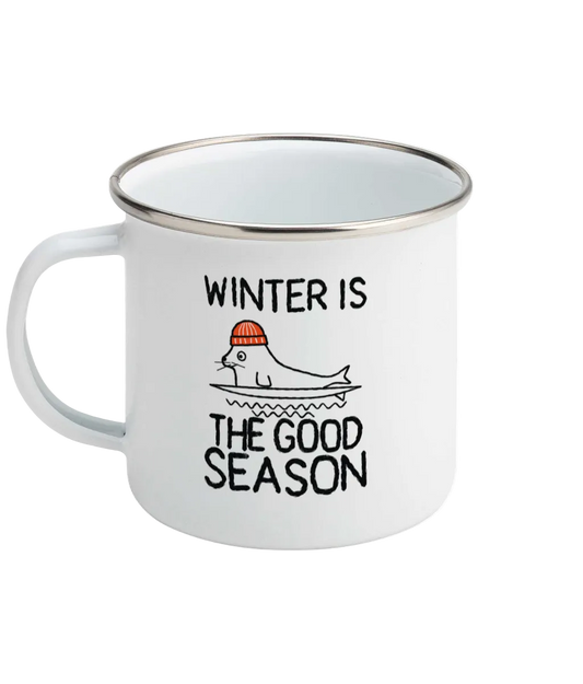 SVRF Enamel Mug in white with a silver rim, showing Winter Is The Good Season print and a seal in an orange beanie on a surfboard
